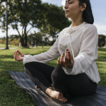 vertical-shot-hispanic-female-doing-yoga-park 1